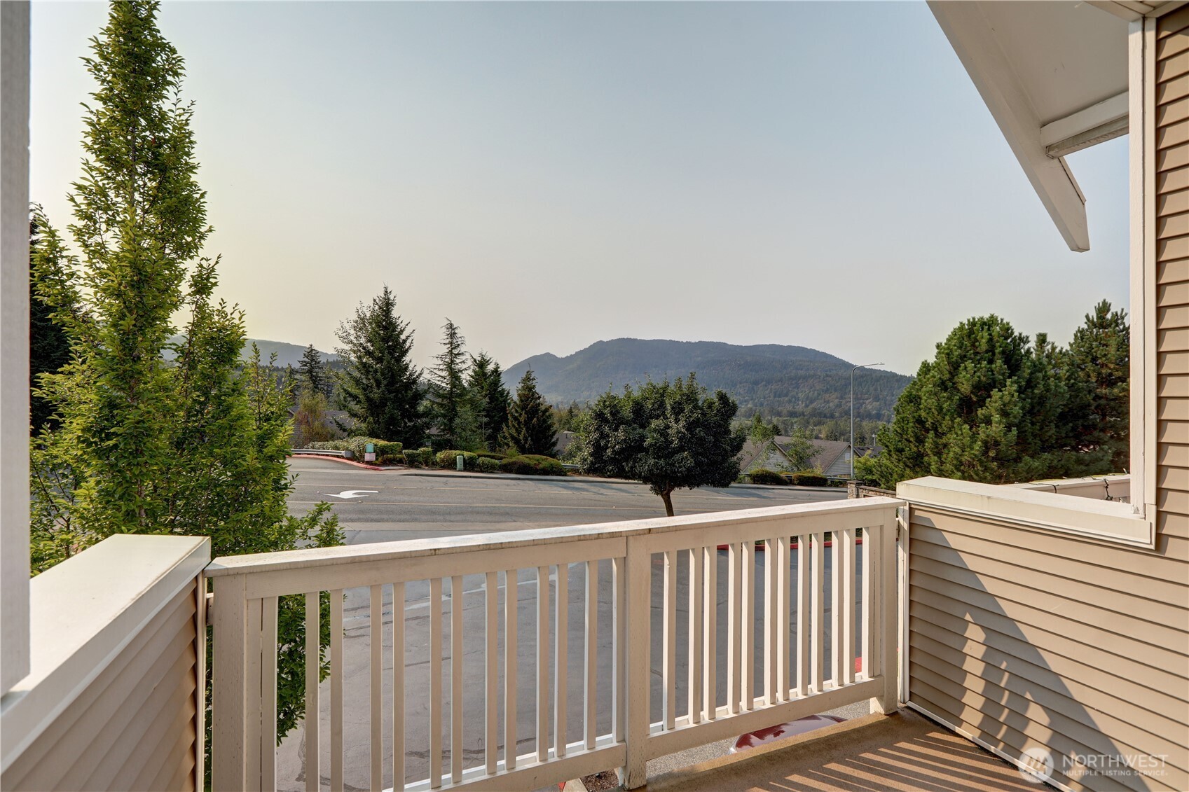 a view of a balcony with wooden fence and floor