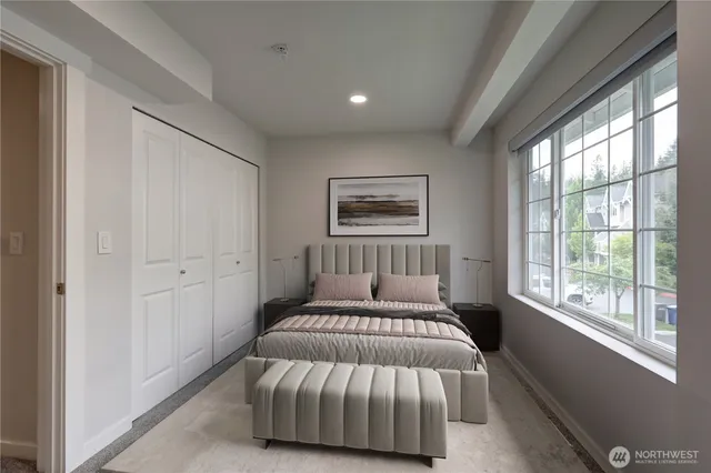 a bedroom with a large bed and a window