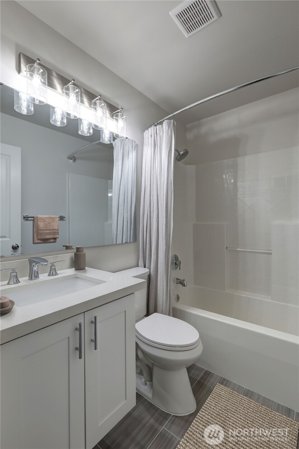 23120 Southeast Black Nugget Road, Unit A2 Issaquah, WA 98029 - Photo 12 of 18 a bathroom with a sink a toilet and shower