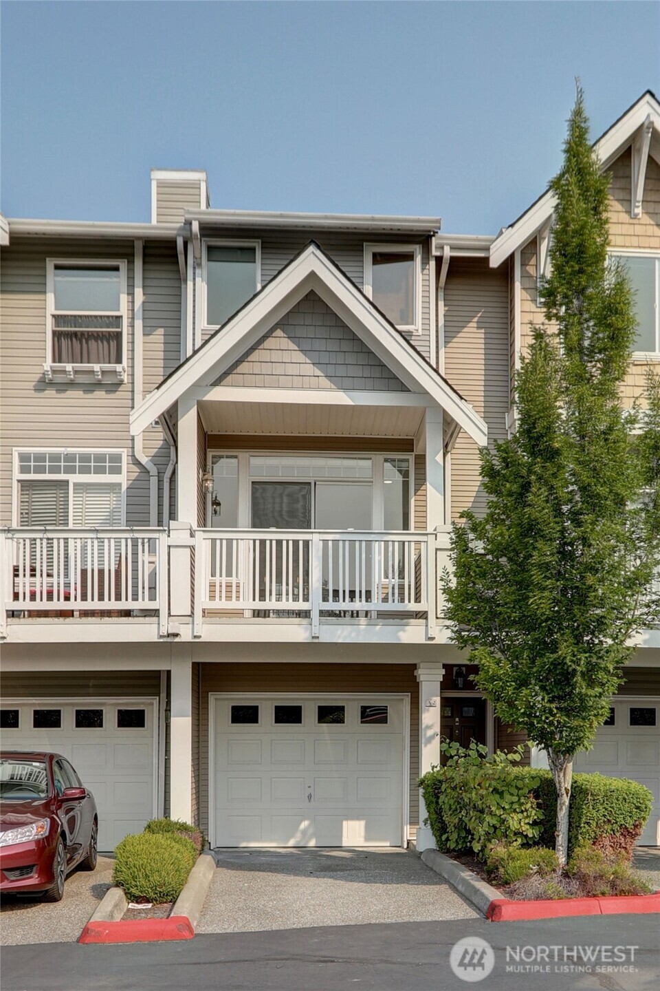 23120 Southeast Black Nugget Road, Unit A2 Issaquah, WA 98029 - Photo 16 of 18 a front view of a house with a yard