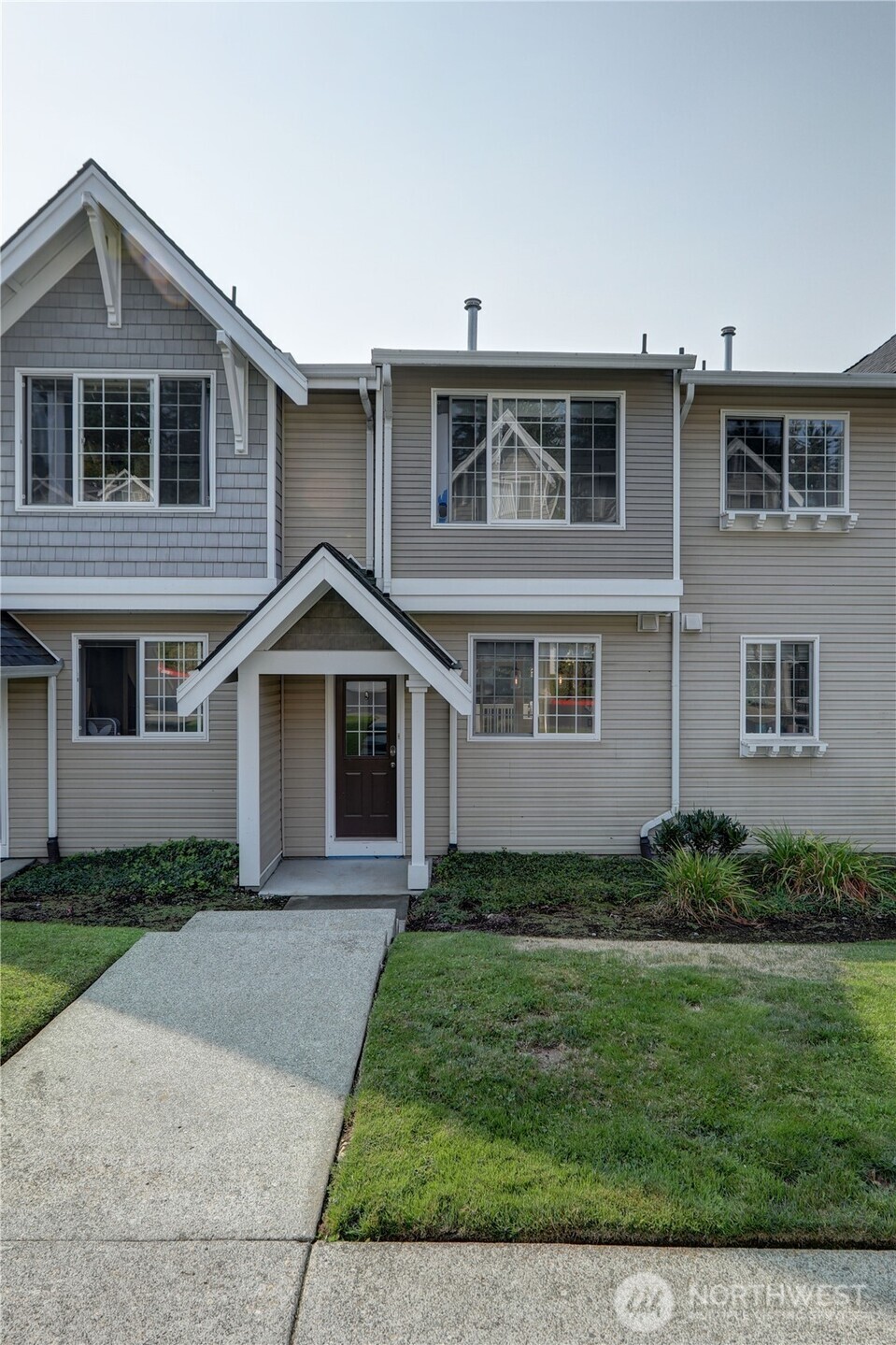 23120 Southeast Black Nugget Road, Unit A2 Issaquah, WA 98029 - Photo 17 of 18 a front view of a house with a yard