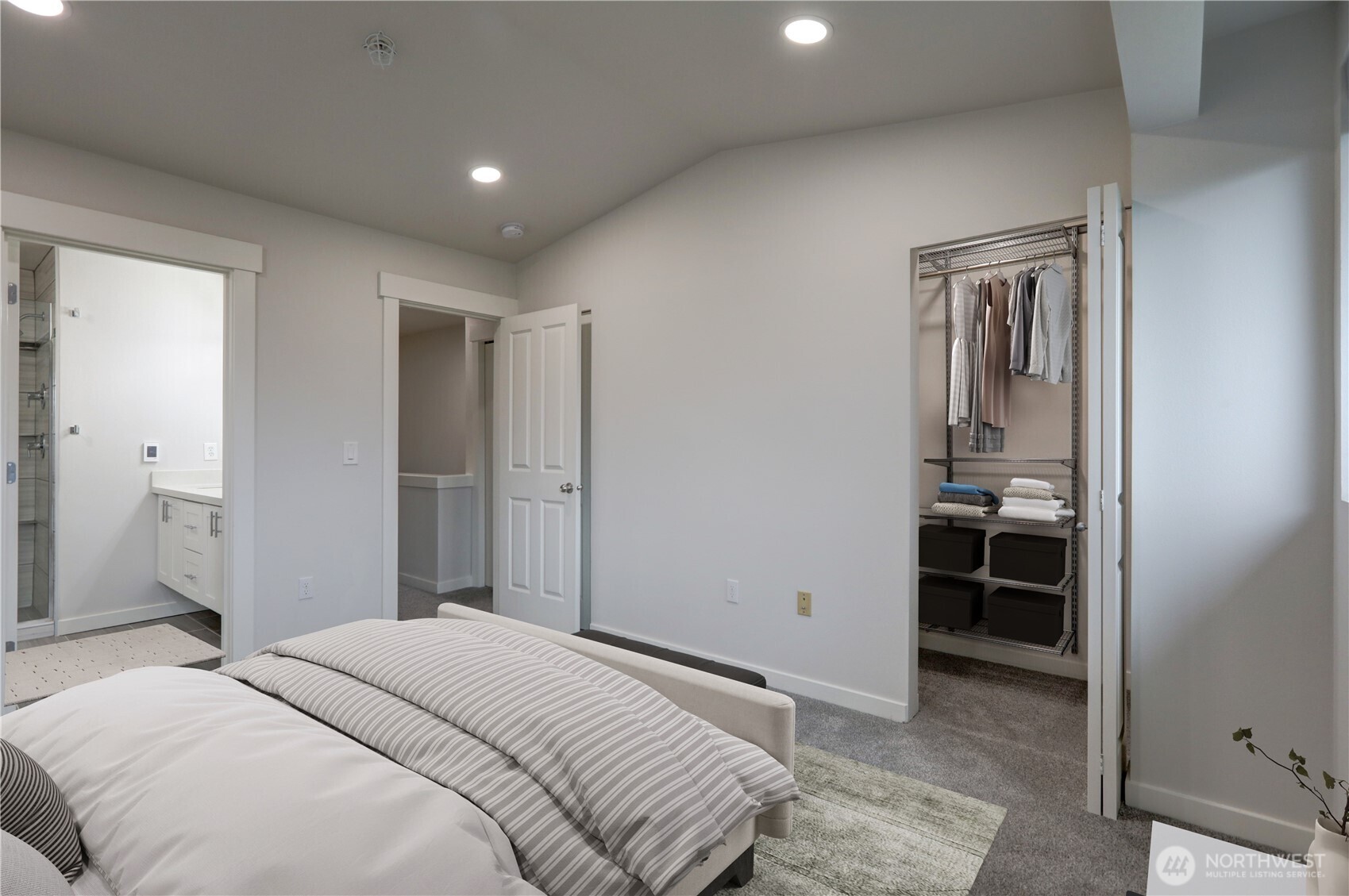 23120 Southeast Black Nugget Road, Unit A2 Issaquah, WA 98029 - Photo 8 of 18 a bedroom with a bed and a sink