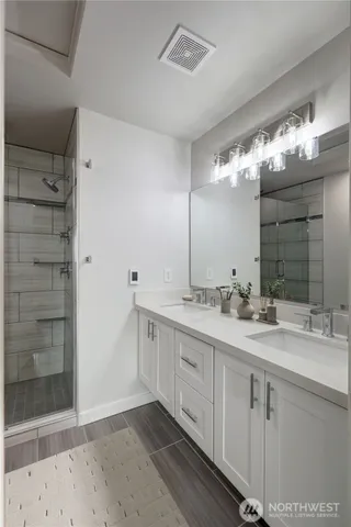 a bathroom with a double vanity sink and a mirror