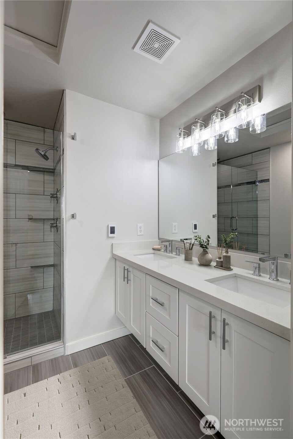 23120 Southeast Black Nugget Road, Unit A2 Issaquah, WA 98029 - Photo 9 of 18 a bathroom with a double vanity sink and a mirror