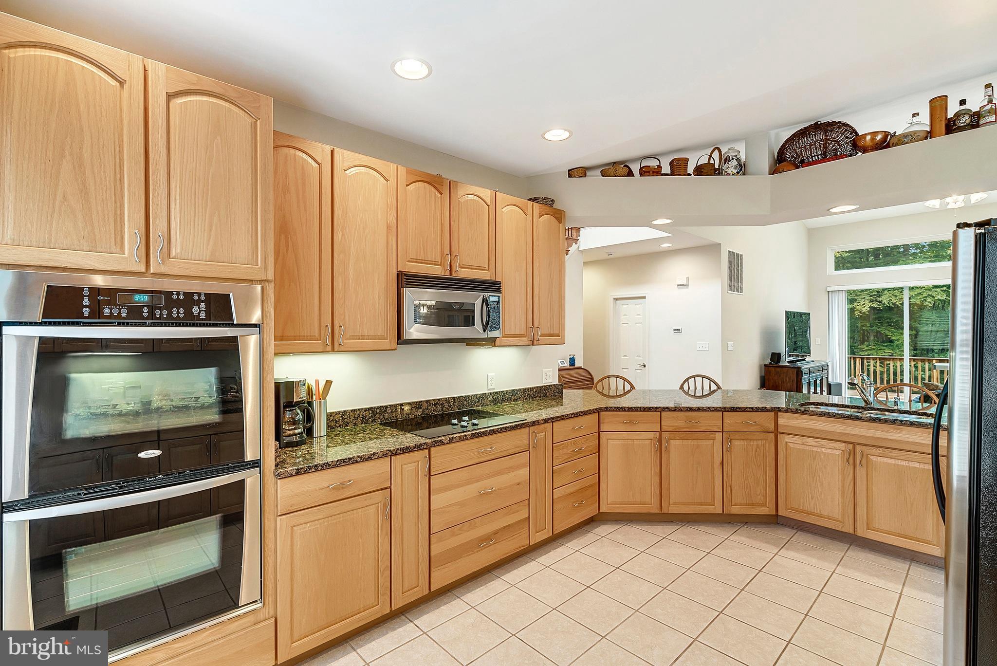 14303 Reva Road Reva, VA 22735 - Photo 12 of 25 a large kitchen with stainless steel appliances granite countertop a sink and cabinets