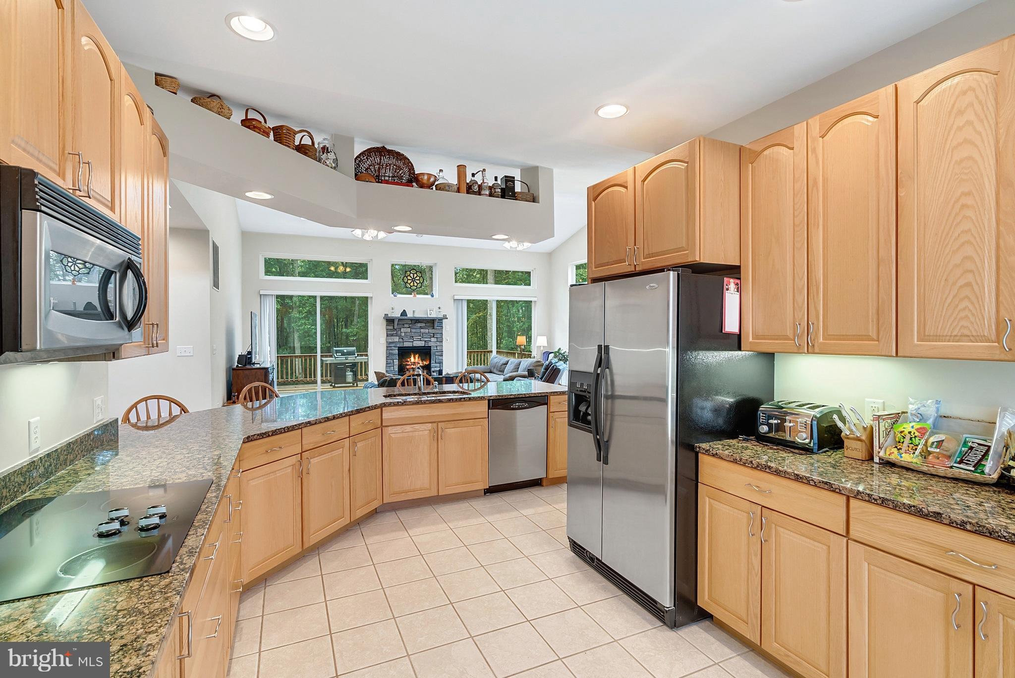 14303 Reva Road Reva, VA 22735 - Photo 13 of 25 a kitchen with stainless steel appliances granite countertop a refrigerator and a stove top oven