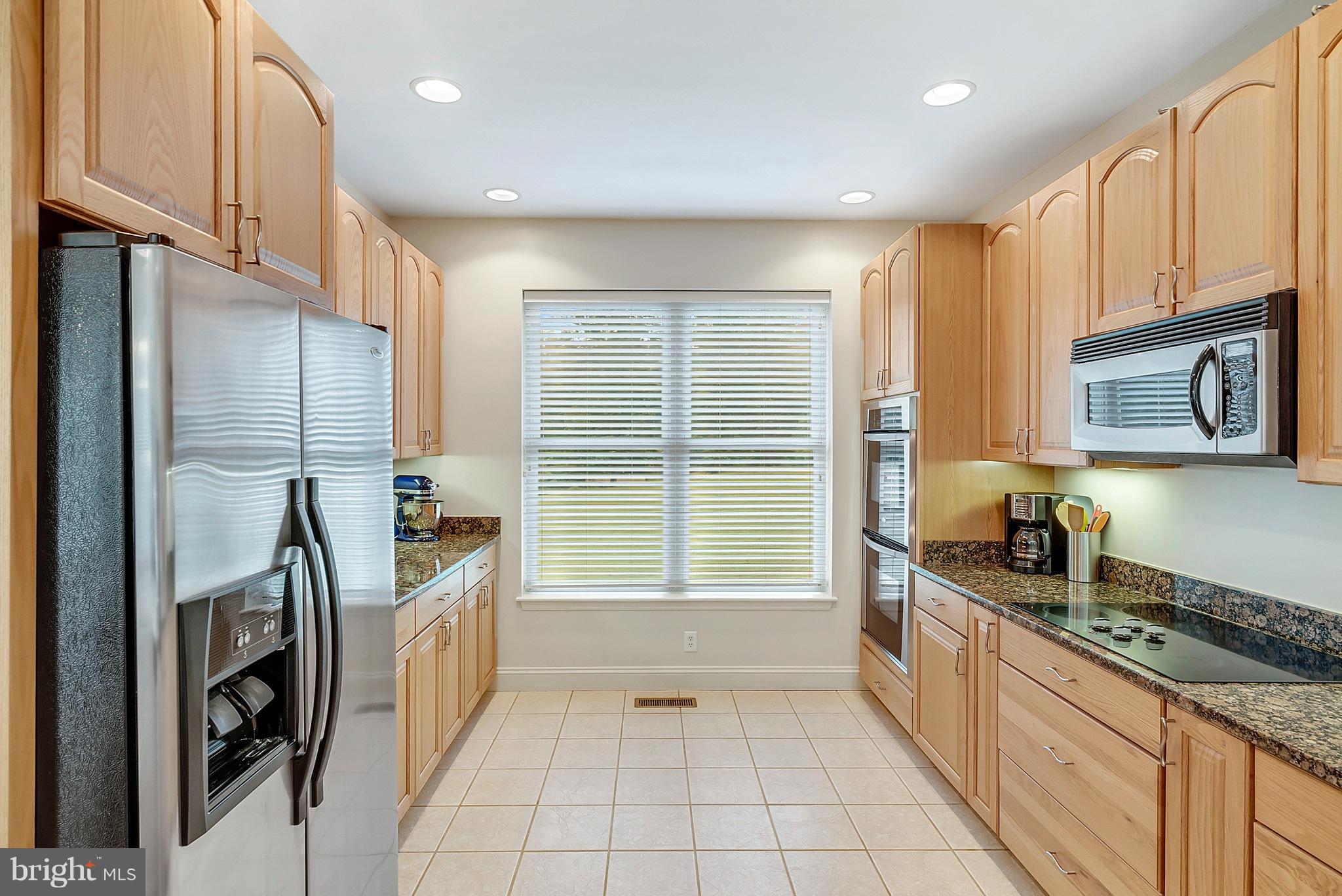 14303 Reva Road Reva, VA 22735 - Photo 14 of 25 a kitchen with stainless steel appliances granite countertop a stove a sink and a refrigerator