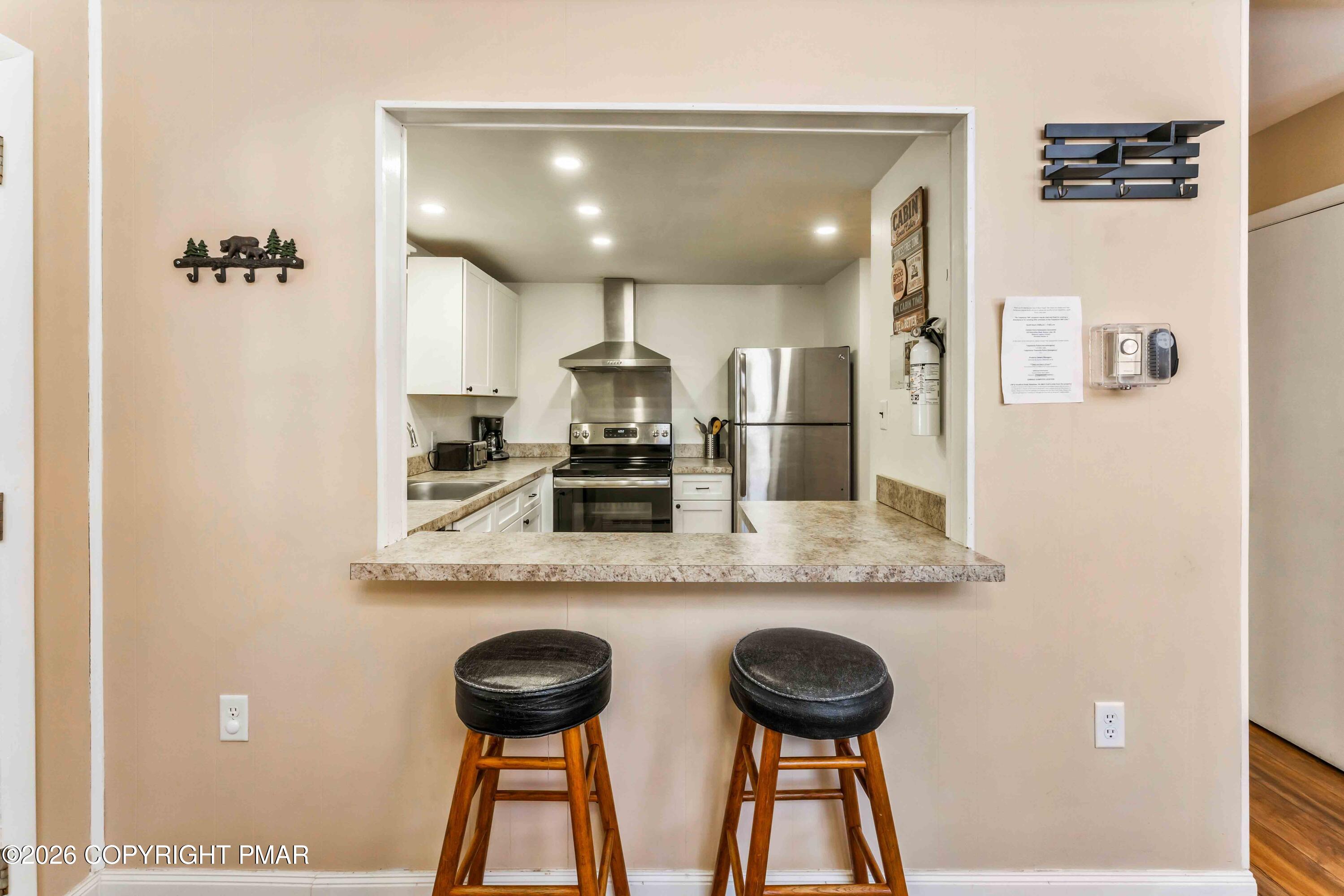 102 King Arthur Road Pocono Lake, PA 18347 - Photo 24 of 59 a kitchen with stainless steel appliances granite countertop a sink a stove a refrigerator a washer dryer and a dining table