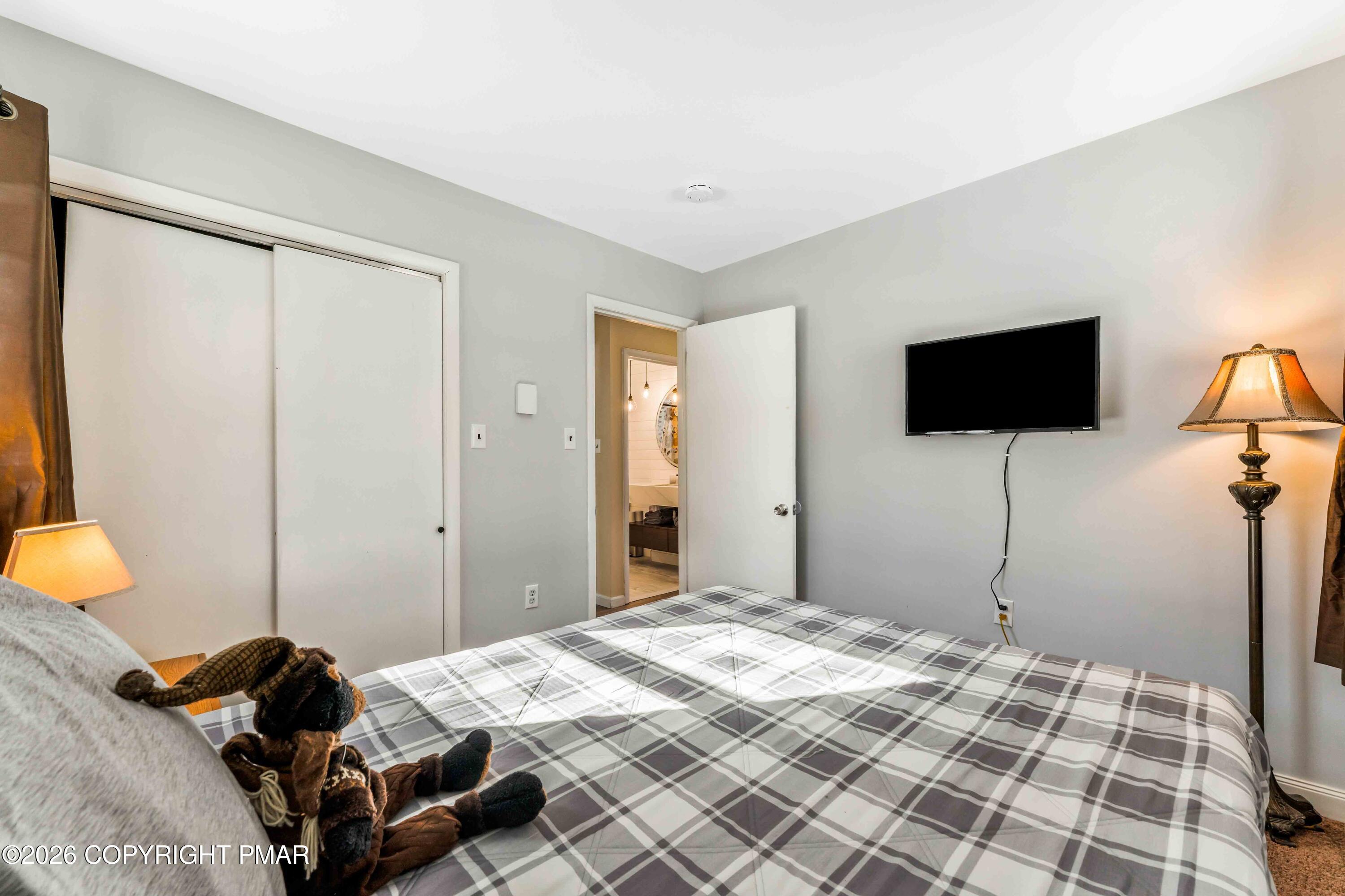 102 King Arthur Road Pocono Lake, PA 18347 - Photo 26 of 59 a bedroom with a bed and a flat screen tv