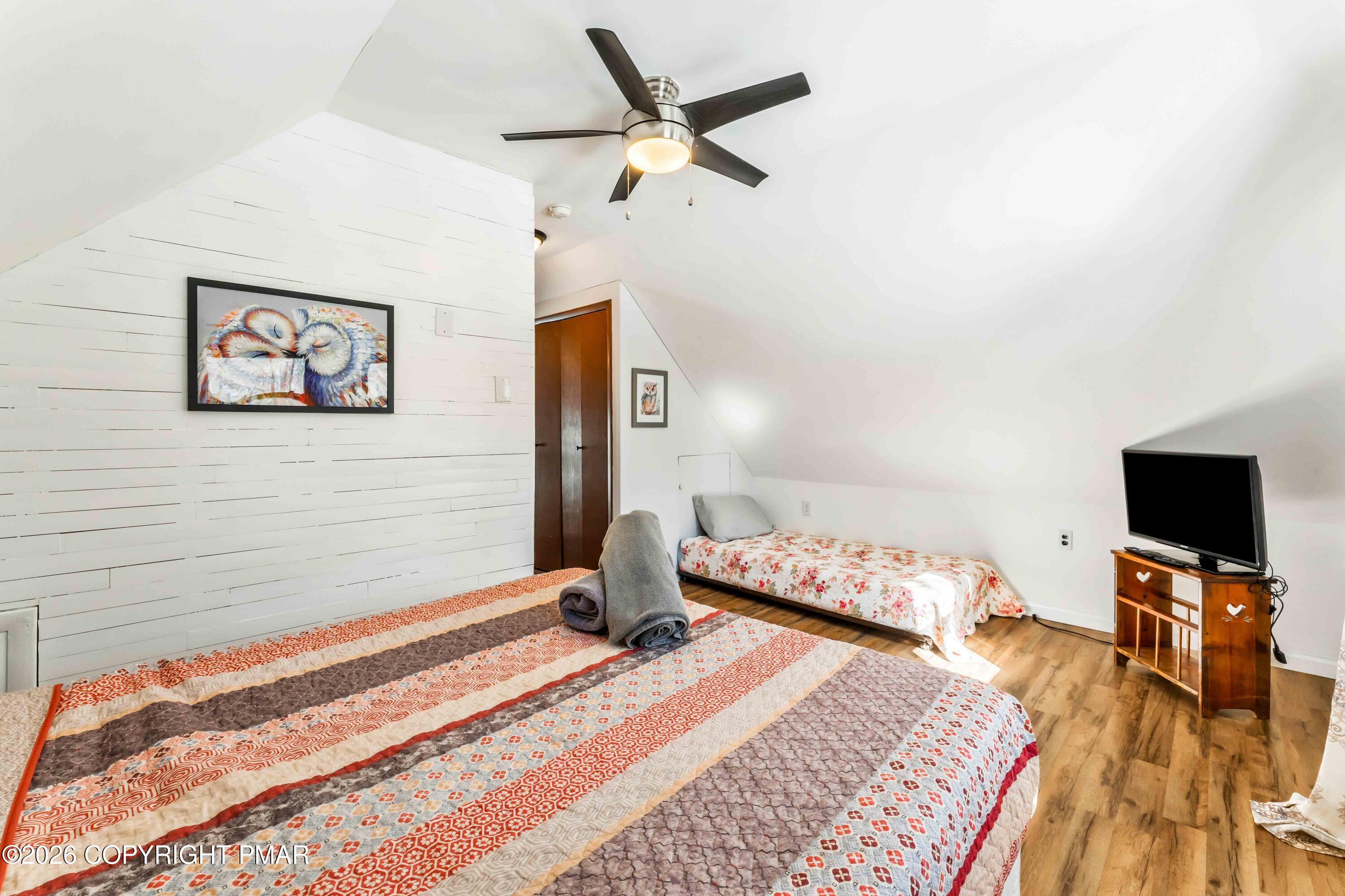 102 King Arthur Road Pocono Lake, PA 18347 - Photo 34 of 59 a bedroom with a bed and a flat screen tv