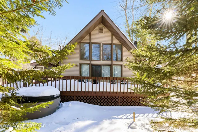 a kitchen with stainless steel appliances granite countertop a sink a stove a refrigerator a washer dryer and a dining table