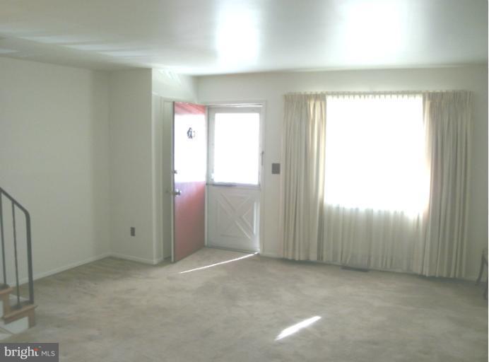 1154 Cedarcroft Road Baltimore, MD 21239 - Photo 7 of 7 an empty room with windows