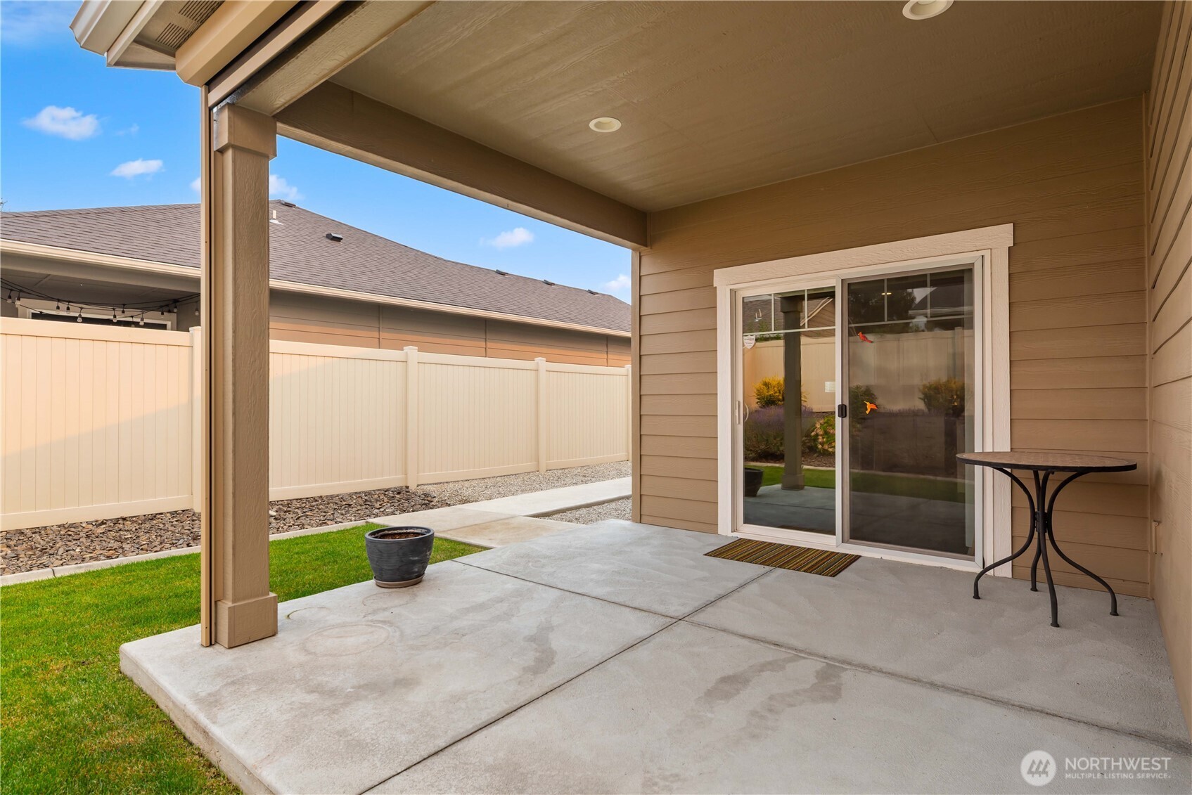 204 Pershing Circle Wenatchee, WA 98801 - Photo 32 of 33 a view of a patio with a table and chairs and wooden fence