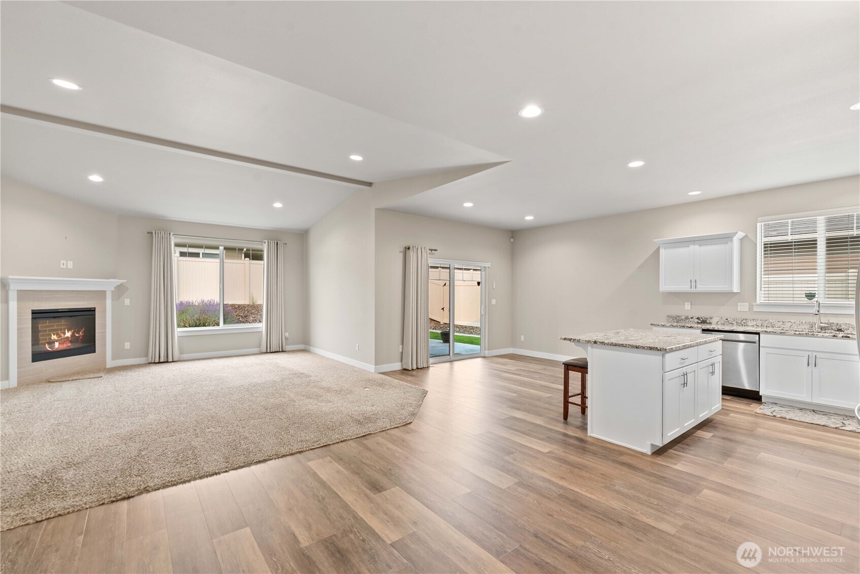 204 Pershing Circle Wenatchee, WA 98801 - Photo 4 of 33 a large kitchen with kitchen island granite countertop a stove and a refrigerator a sink with wooden floors