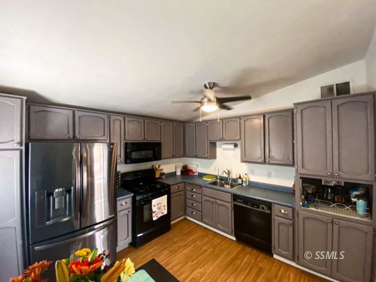 333 North Helena Street Ridgecrest, CA 93555 - Photo 6 of 35 a kitchen with granite countertop a refrigerator stove top oven and sink