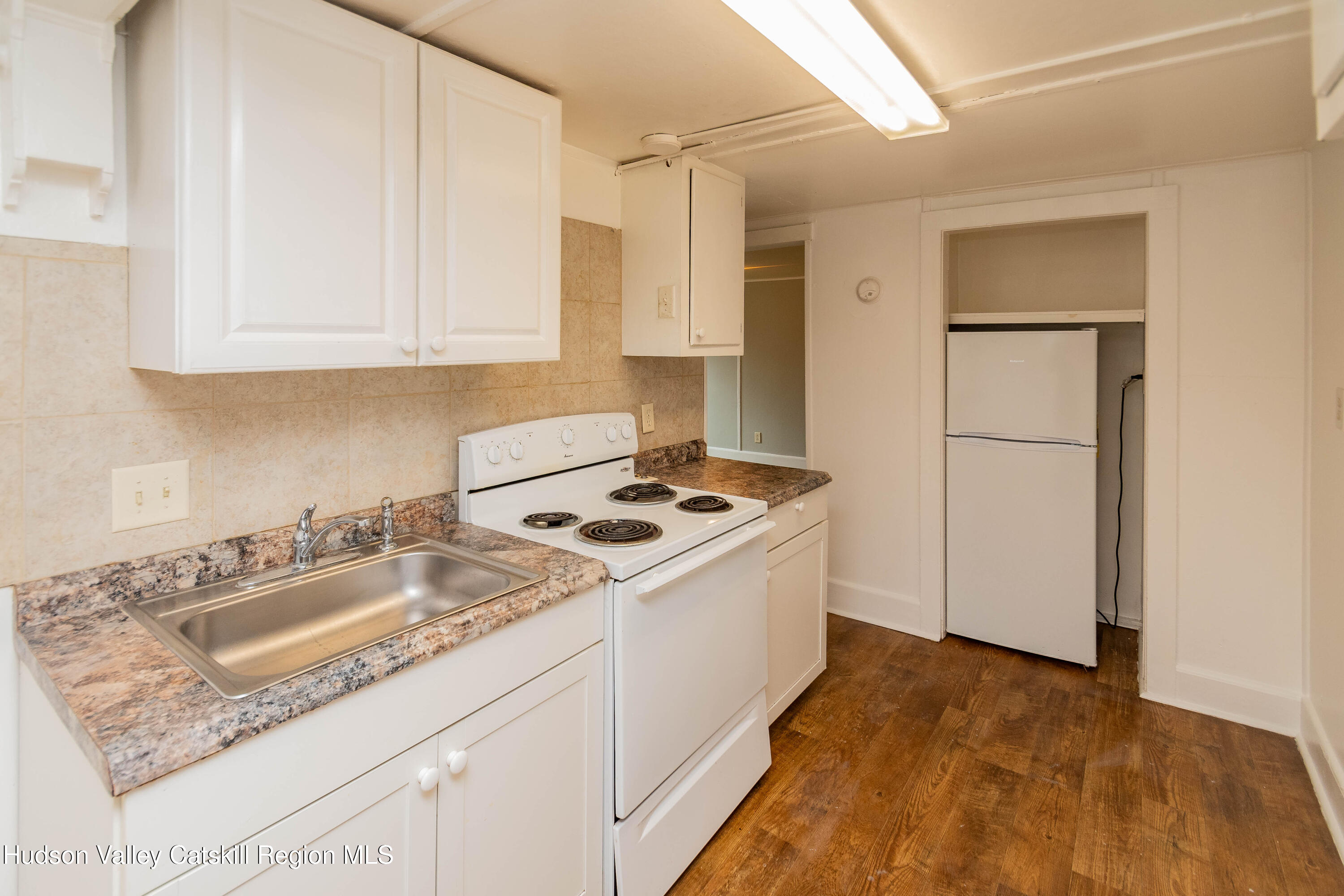 131 Station Road New Paltz, NY 12561 - Photo 15 of 31 a kitchen with a sink stove and refrigerator