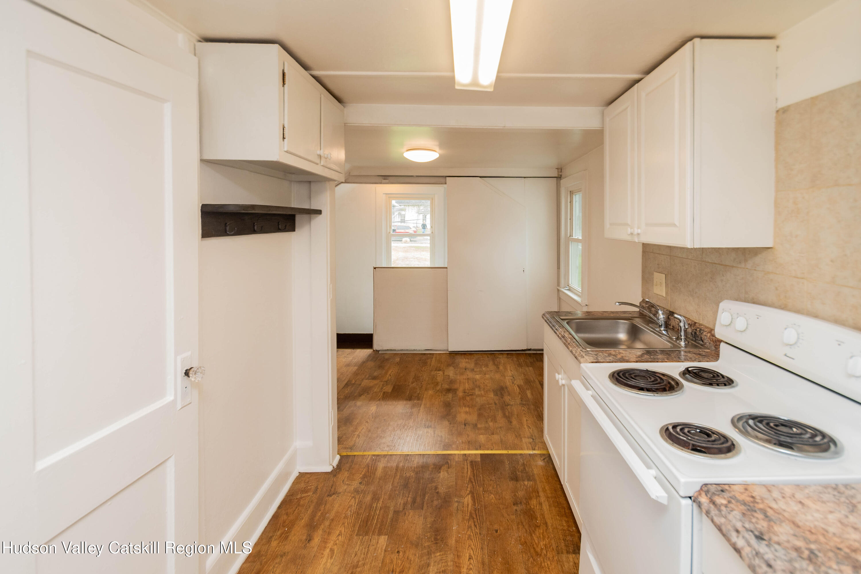 131 Station Road New Paltz, NY 12561 - Photo 17 of 31 a kitchen with a stove a sink and a refrigerator