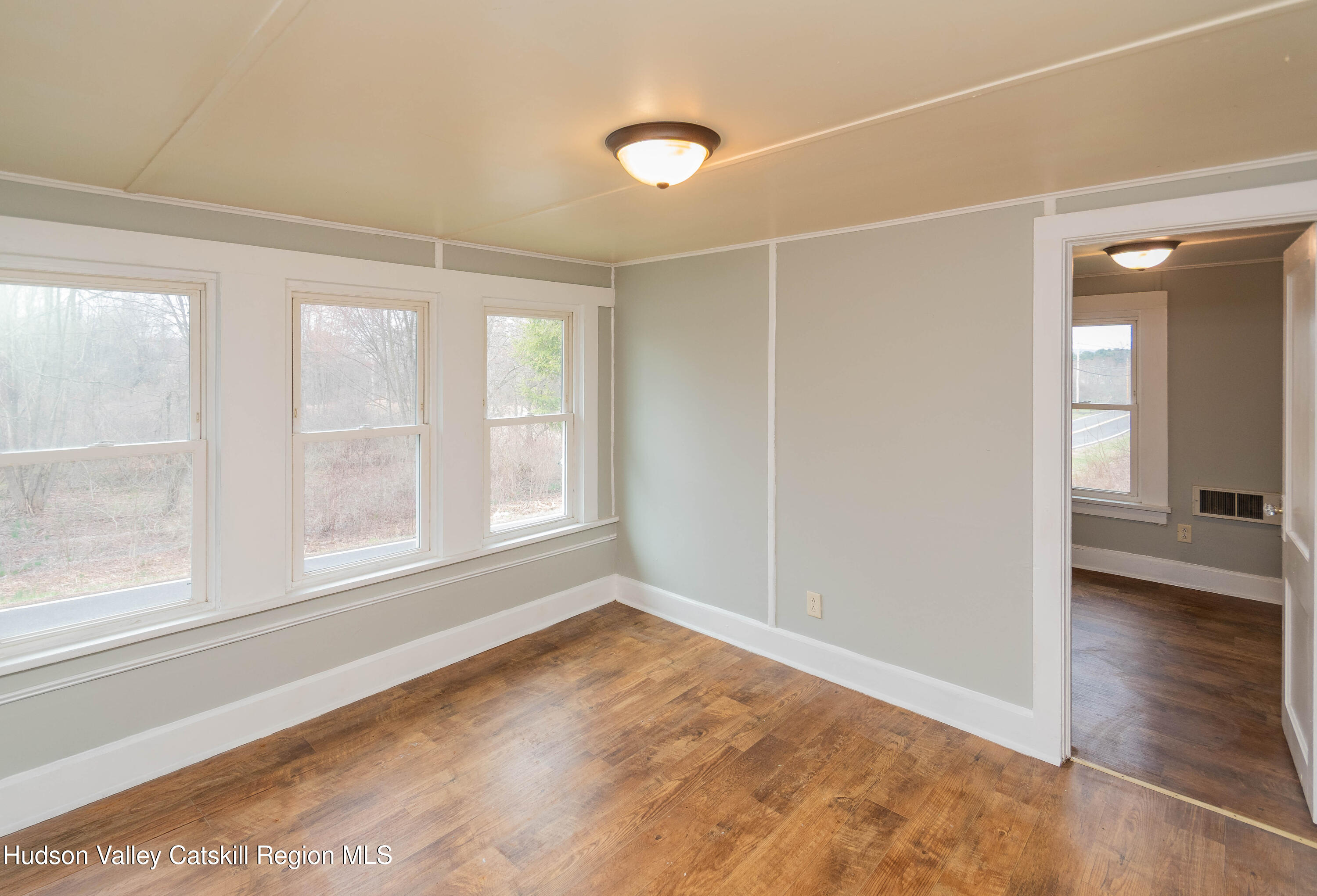 131 Station Road New Paltz, NY 12561 - Photo 20 of 31 a view of an empty room with wooden floor and a window