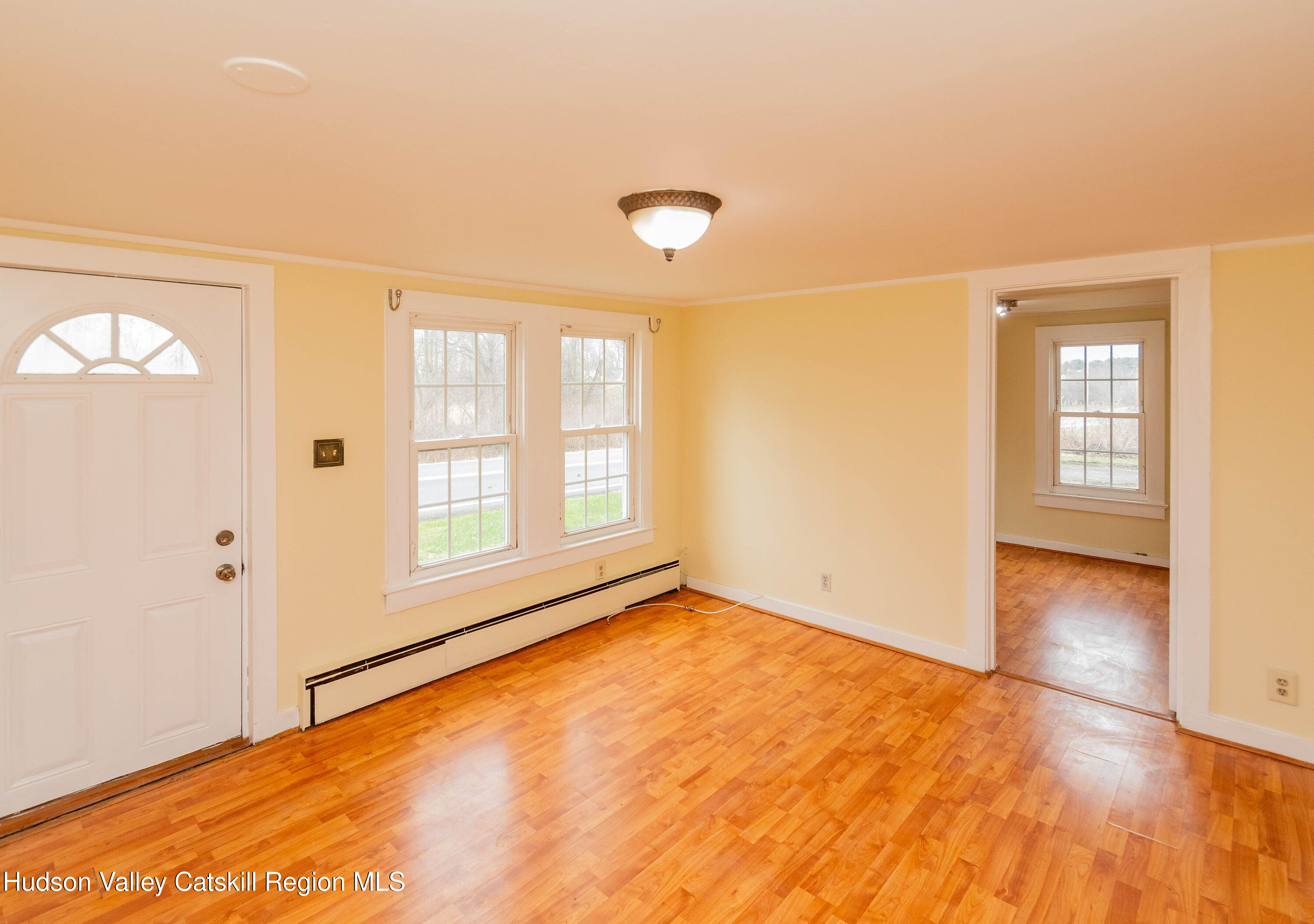 131 Station Road New Paltz, NY 12561 - Photo 2 of 31 an empty room with wooden floor and windows