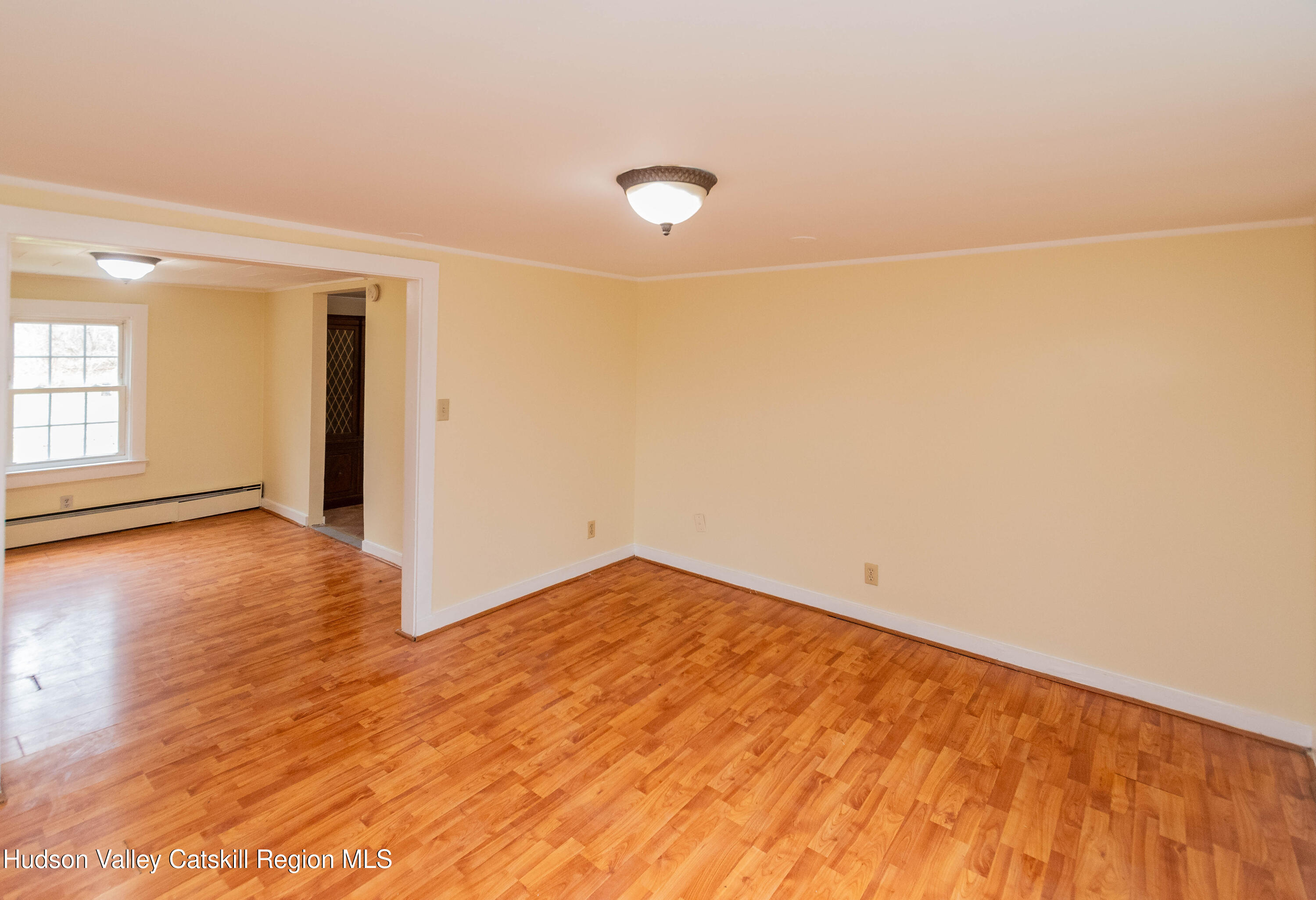 131 Station Road New Paltz, NY 12561 - Photo 5 of 31 an empty room with wooden floor and windows