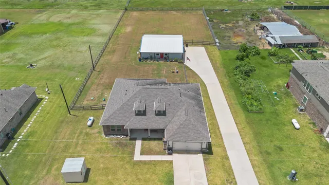 an aerial view of a house with swimming pool