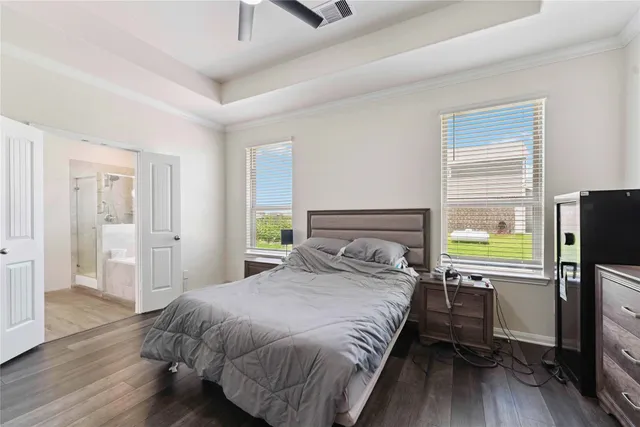 a bedroom with a bed flat screen tv and window
