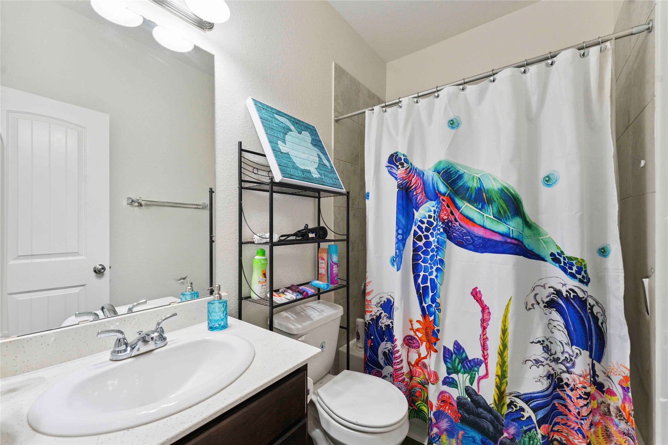 7718 Kovar Road Beasley, TX 77417 - Photo 21 of 30 a bathroom with a sink toilet and shower curtain