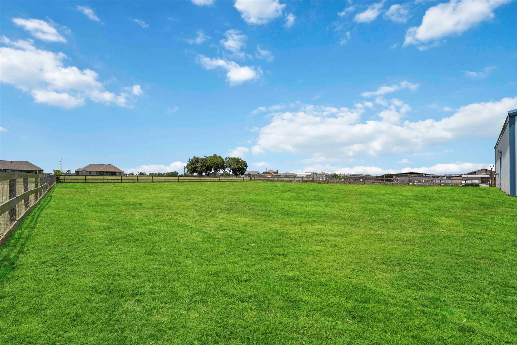7718 Kovar Road Beasley, TX 77417 - Photo 29 of 30 a backyard of a house with lots of green space and mountain view in back