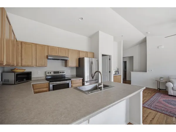 a kitchen with kitchen island a sink stove and refrigerator