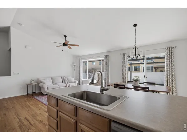 a kitchen with a sink dishwasher a fireplace with wooden floor