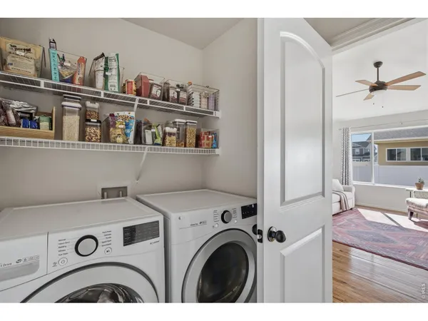a utility room with dryer washer and a view of living room