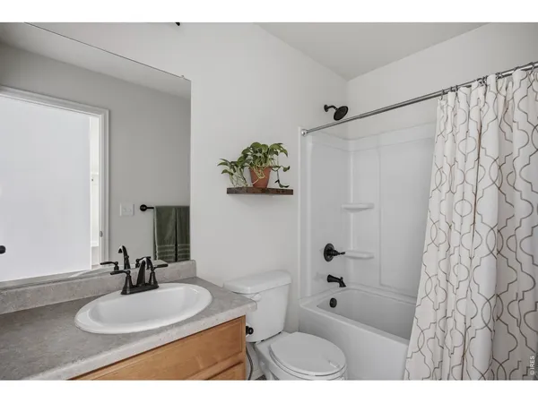 a bathroom with a sink toilet a mirror and shower