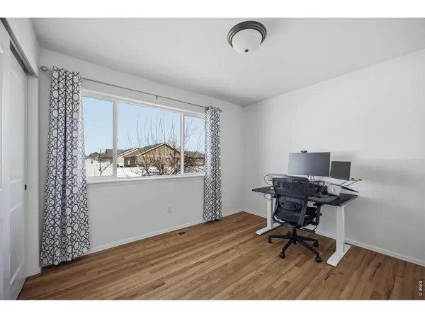 a workspace with furniture and wooden floor