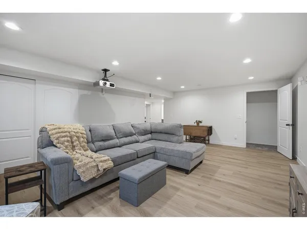 a living room with furniture and a ceiling fan