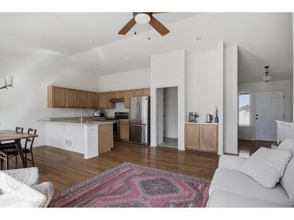 a living room with furniture and kitchen view