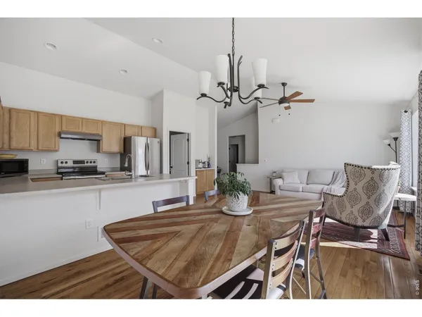 a kitchen with a dining table and chairs
