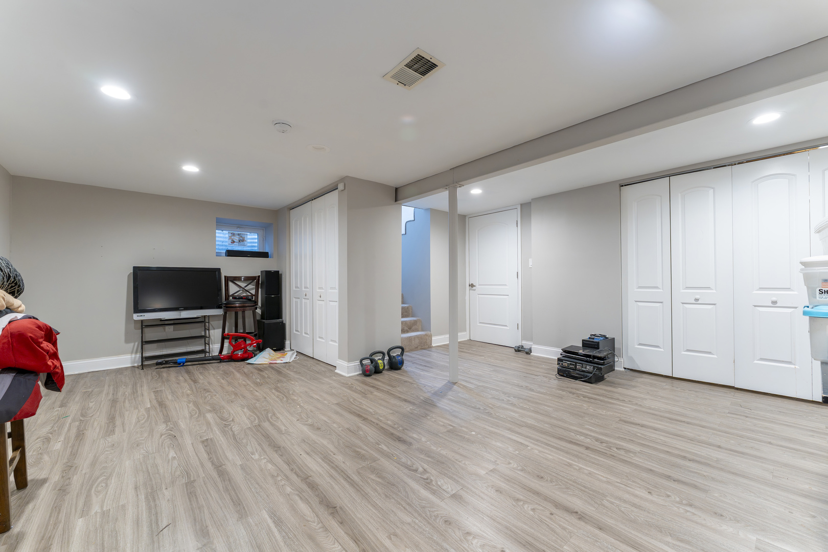 513 Jill Lane Bolingbrook, IL 60440 - Photo 17 of 20 a view of a room with gym equipment and a flat screen tv