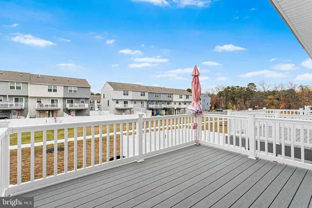 a view of balcony with wooden floor and fence
