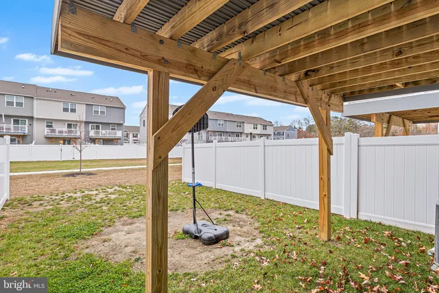 a front view of a house with a yard table and chairs