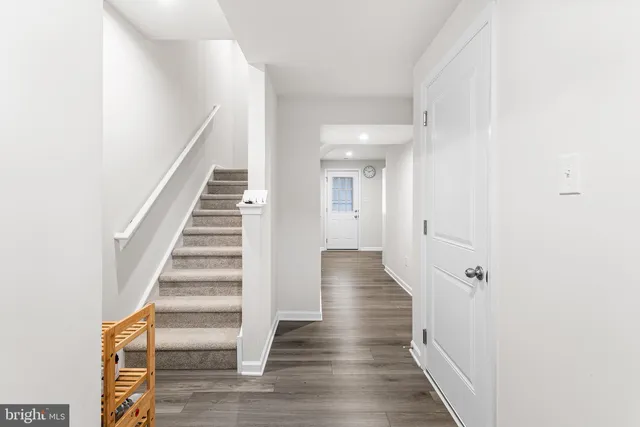 a view of a hallway with wooden floor and entryway