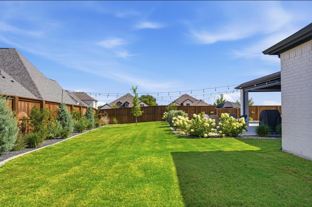 4202 Crown Run Road Midlothian, TX 76065 - Photo 28 of 34 Expansive green lawn with string lighting overhead