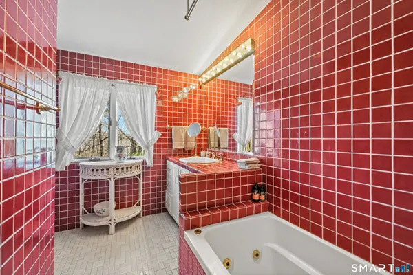 a bathroom with a bathtub and shower