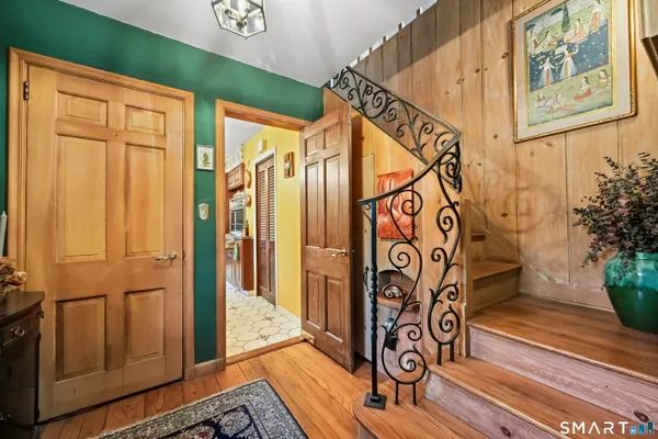 a view of an entryway with wooden floor