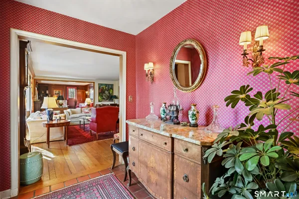 a bathroom with a sink a mirror and a potted plant