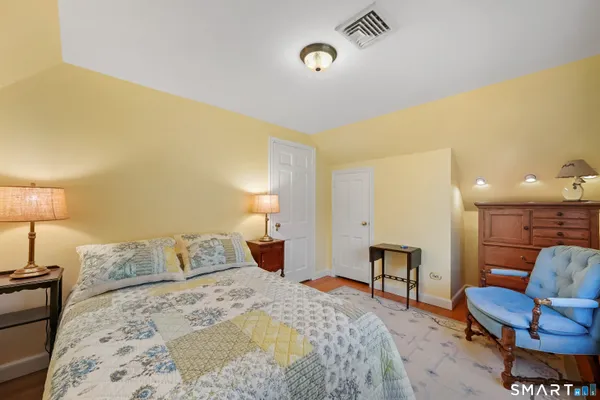 a bedroom with a bed and chair