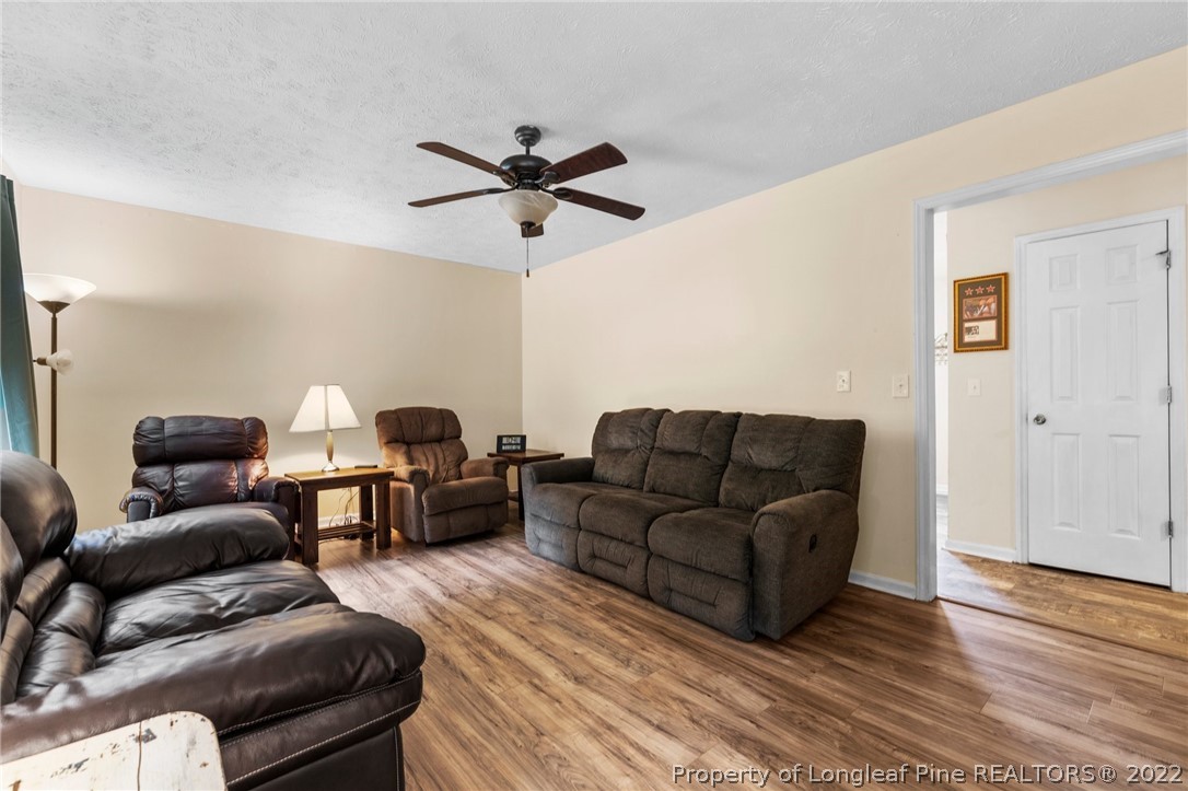 15921 Palmer Road Marston, NC 28363 - Photo 21 of 39 a living room with furniture and a wooden floor