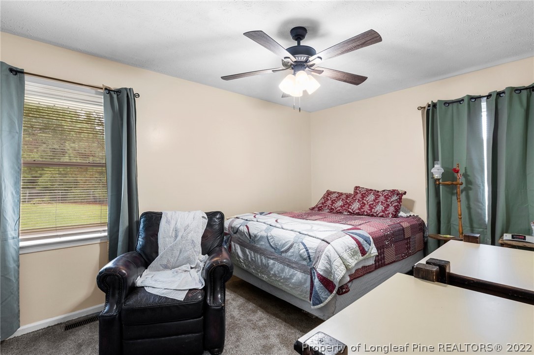 15921 Palmer Road Marston, NC 28363 - Photo 27 of 39 a bedroom with a bed and glass window