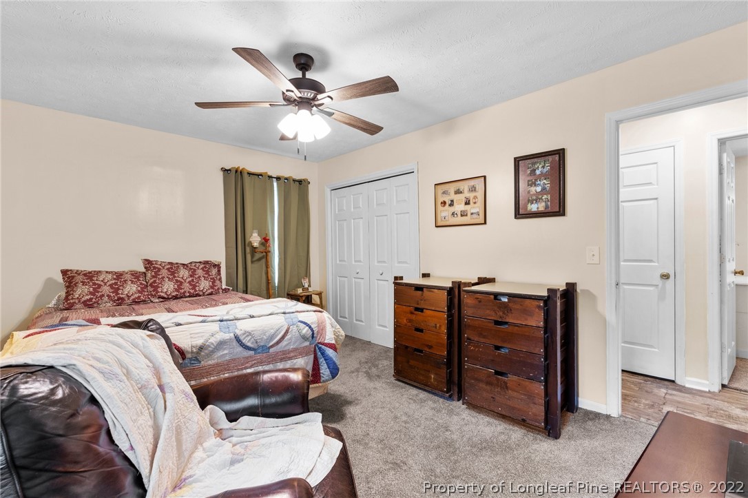 15921 Palmer Road Marston, NC 28363 - Photo 30 of 39 a bedroom with a bed and a chandelier