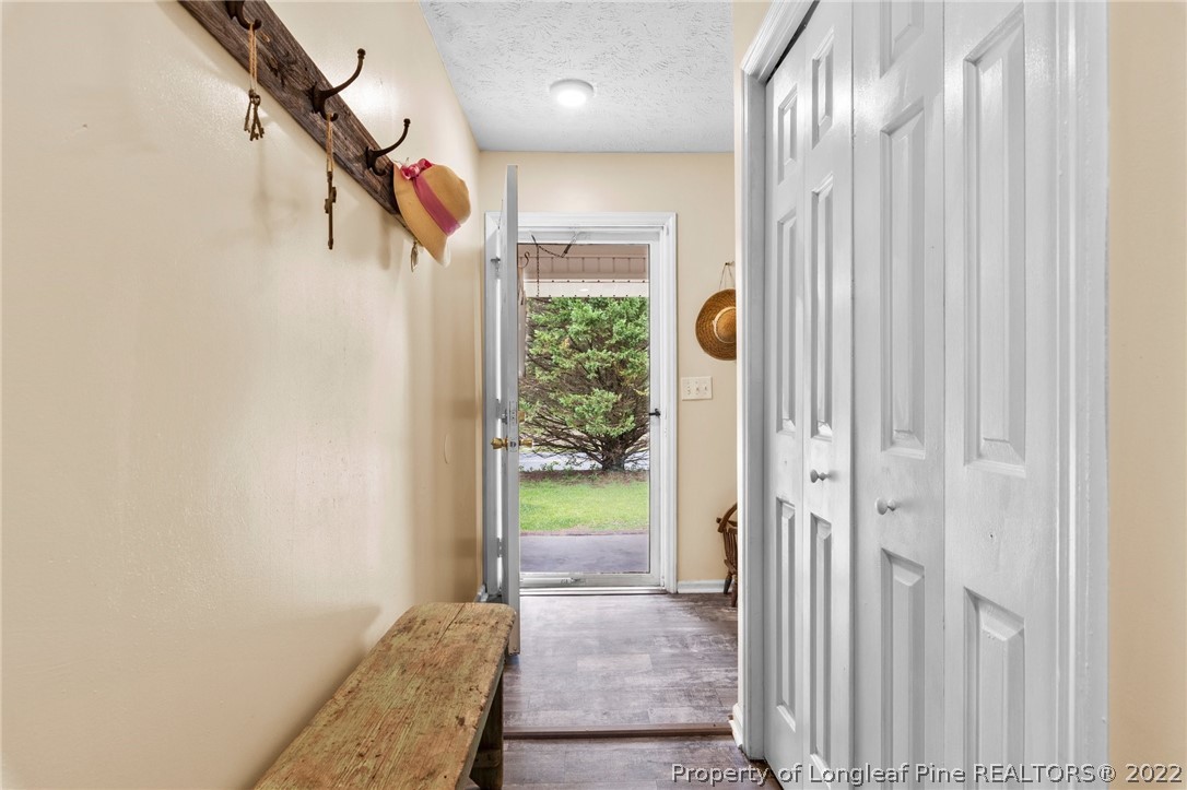 15921 Palmer Road Marston, NC 28363 - Photo 31 of 39 a view of a hallway with wooden floor and staircase