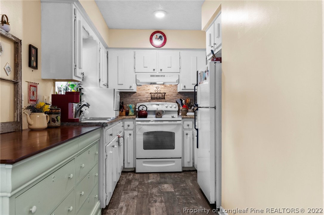 15921 Palmer Road Marston, NC 28363 - Photo 34 of 39 a kitchen with cabinets and white appliances